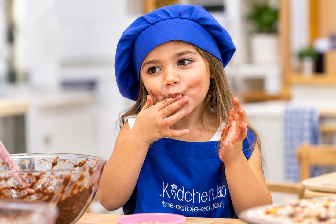 Child enjoying what she made