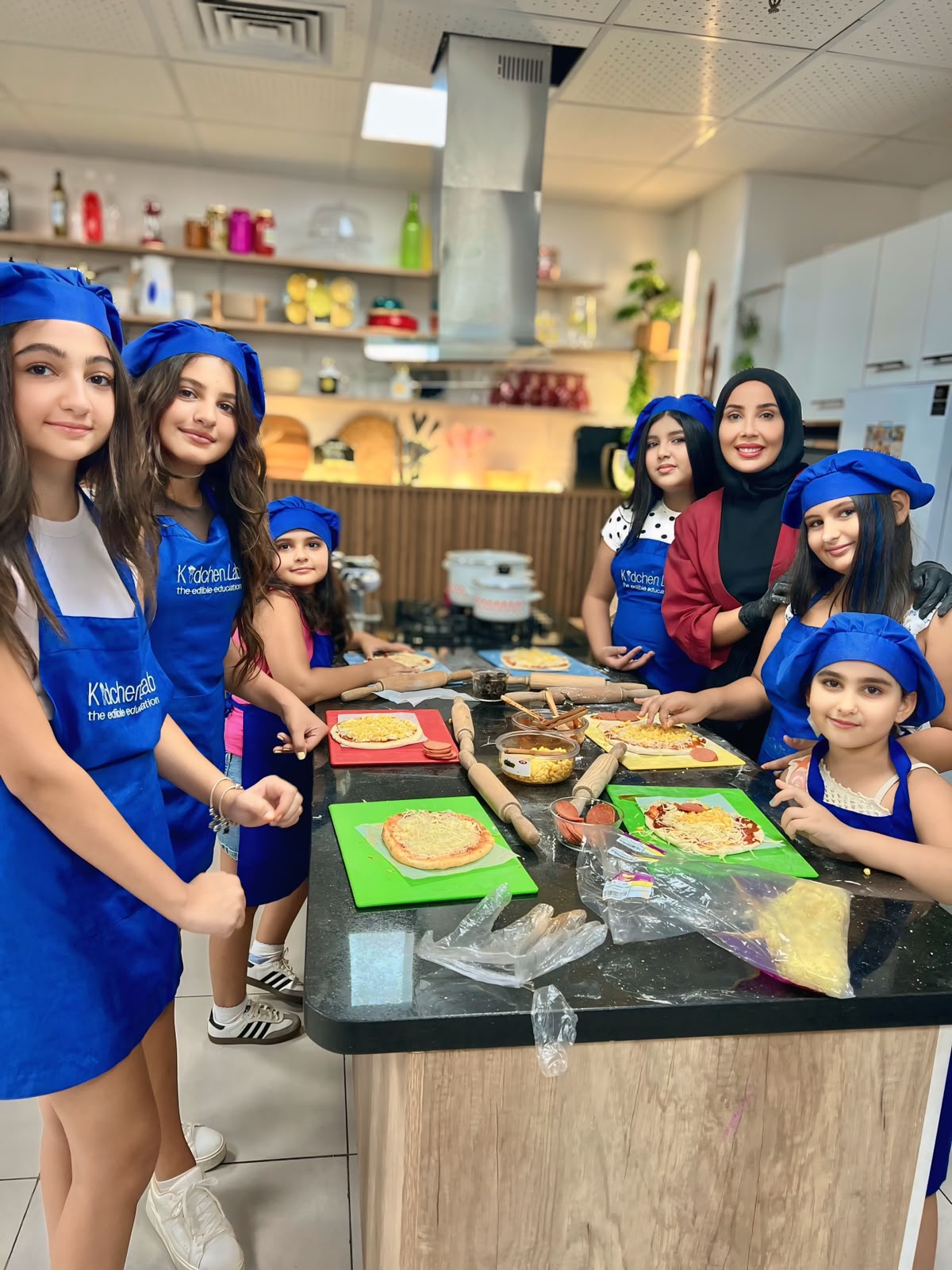 Children making pizza together at Kidchen Club
