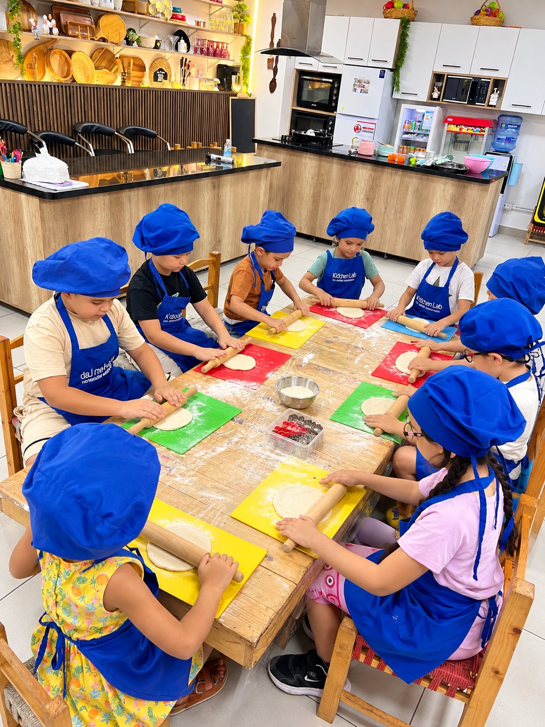 A class rolling dough together at Kidchen Club